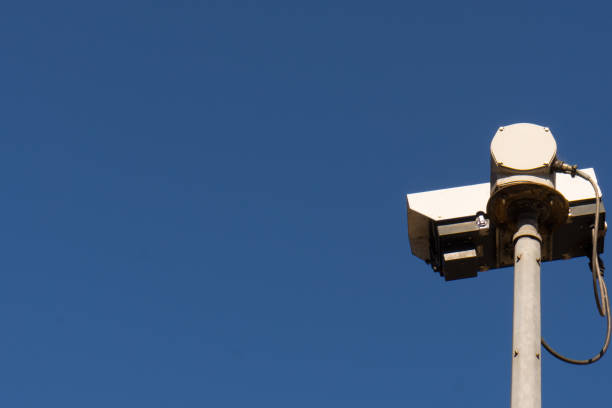 istock Closeup surveillance video camera blue sky 1422361757