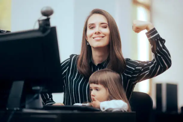 Photo of Strong Mom Flexing Her Muscles while Multitasking at Work