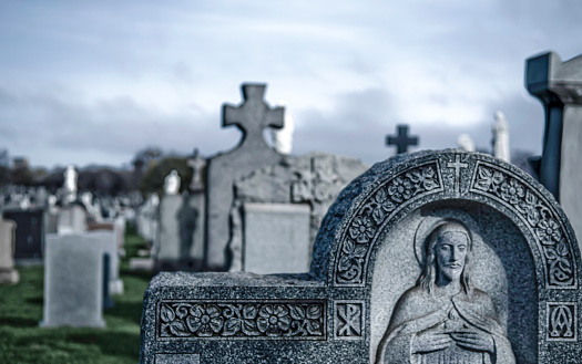 Other graves and trees in background