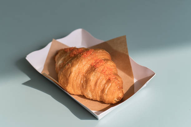 Fresh croissant served in white paper plate stock photo