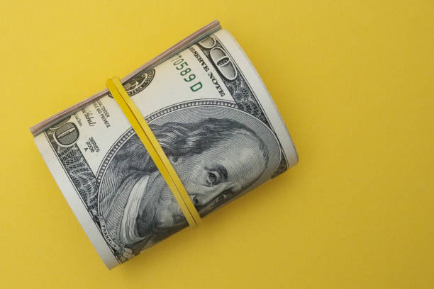 istock Dollars rolled up into a tube. 1422391789