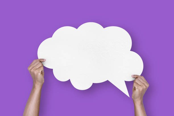 istock hand holding white paper cloud shape speech bubble balloon isolated on purple background communication bubbles 1422395133