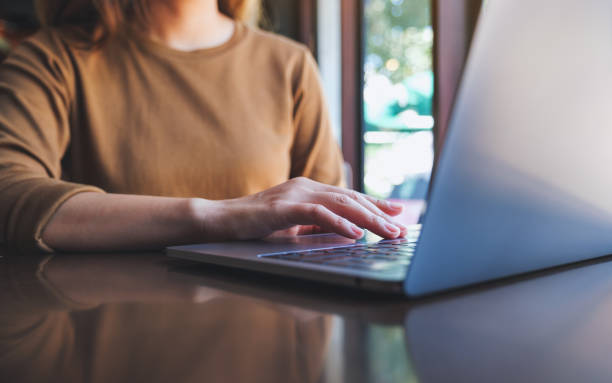 istock Closeup image of a woman working and touching on laptop computer touchpad 1422398395