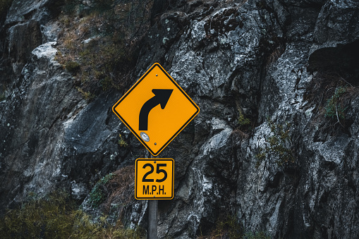 Close-up of a speed limit turning sign in Yosemite National Park. Seen in California, USA, in the spring at daylight.