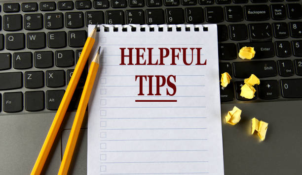 istock HELPFUL TIPS - words in a white notepad on the background of a laptop with pencils 1422416414