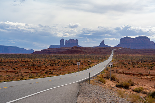 Long straight winding road leading into Monument Valley on the Utah and Arizona border, USA.