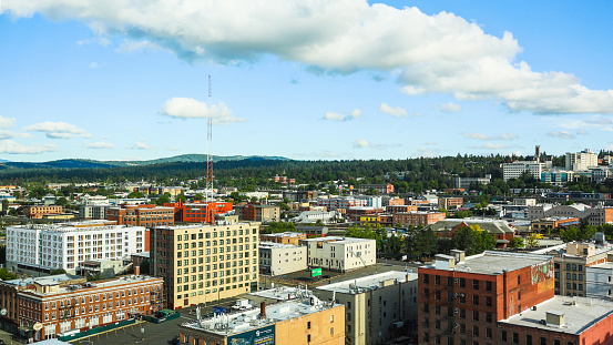 Spokane, Washington, United States - July 4, 2022: View of Downtown Spokane from an elevated viewpoint with office and bank buildings seen from the distance.
