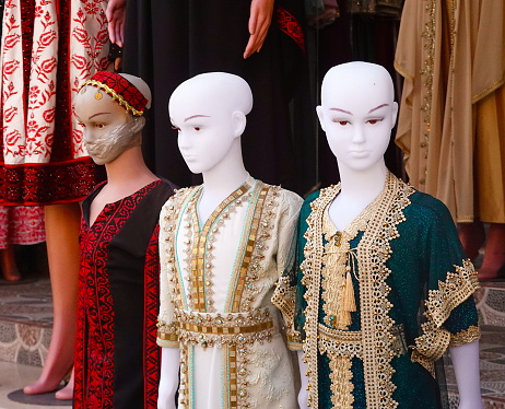 Traditional Middle Eastern and Arab women's dresses on mannequins on the market