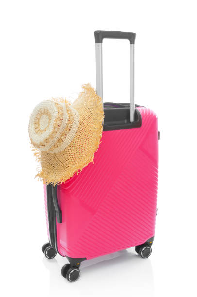 istock Red plastic travel bag with straw hat on white background 1422420864