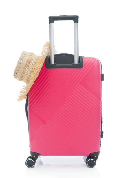 istock Red plastic travel bag with straw hat on white background 1422421068