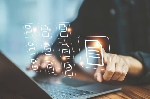 istock Businessman document management concept with icons on virtual screen, ERP 1422421888