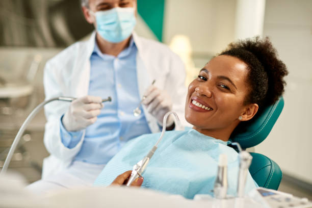 istock Happy black woman at dentist's office looking at camera. 1422423544