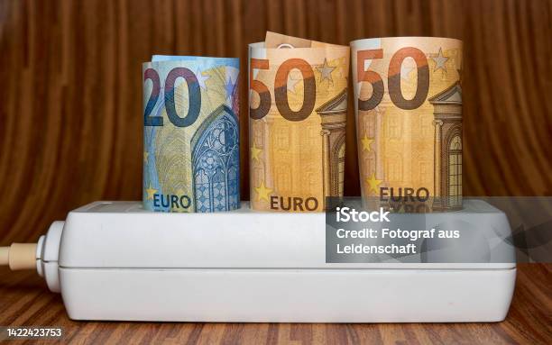 Electric Socket With 50 Euro Bill Rising Electricity Prices And Costly Energy Concept For Families And Businesses Stock Photo - Download Image Now
