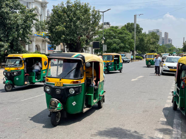 image of indian auto rickshaw taxi cabs, taxi car and yellow and green tuk tuks transporting passengers around connaught place, new delhi, india - consumerism indian ethnicity india delhi imagens e fotografias de stock