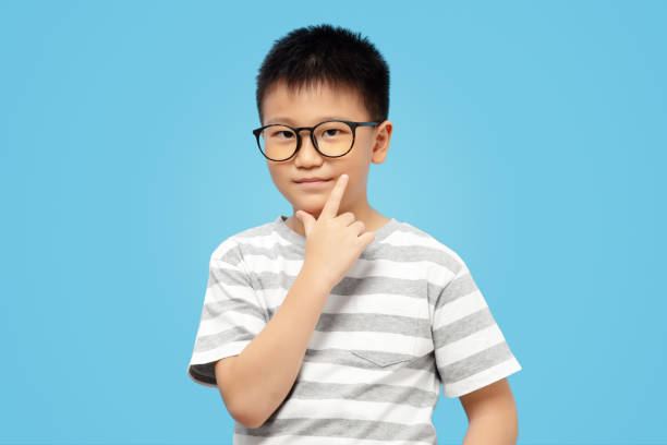 istock Smart kid thinking, wearing eyeglasses with finger on chin 1422429774