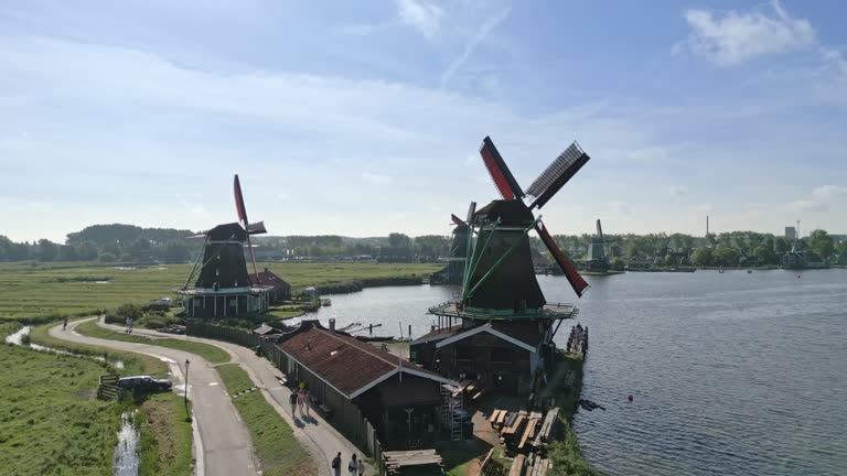 Amsterdam surrounding. Windmills along a River. Dolly push in drone shot.