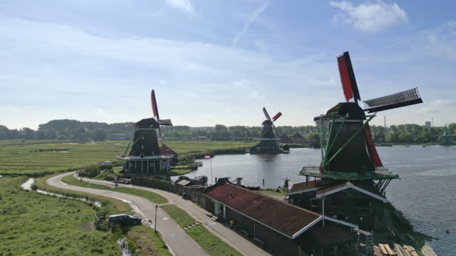 Amsterdam surrounding. Windmills along a River. truck right to left drone shot.
