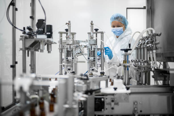 istock Pharmaceutical technician in a protective clothing equipment seen in a laboratory during a manufacturing process 1422441860