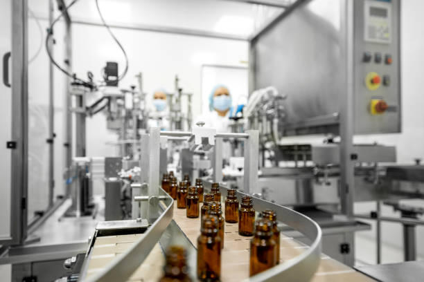 istock Two female employees in a pharmaceutical laboratory seen while controlling the process of drugs manufacturing 1422441955