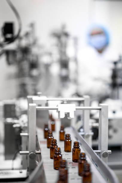 istock Two female employees in a pharmaceutical laboratory seen while controlling the process of drugs manufacturing 1422442038