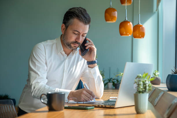 istock Businessman making phone call in office 1422444199