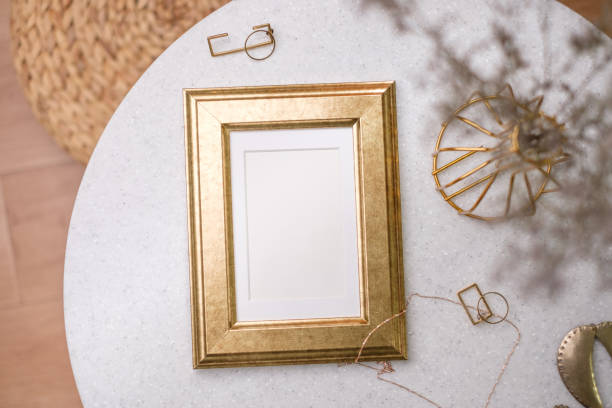 istock mockup gold photo frame on white stone round table with sunlight 1422445585