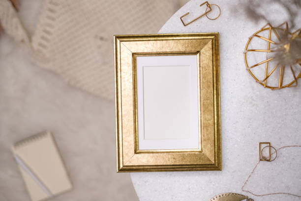 istock mockup gold photo frame on white stone round table with sunlight 1422445640