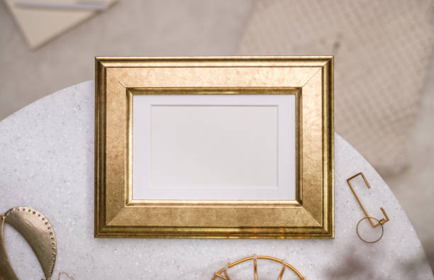 istock mockup gold photo frame on white stone round table with sunlight 1422445653