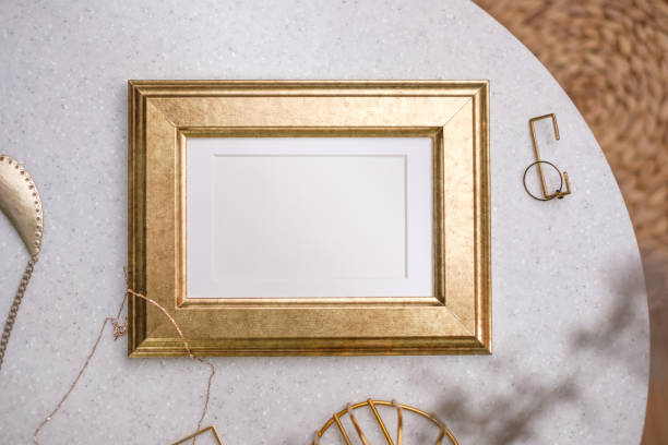 istock mockup gold photo frame on white stone round table with sunlight 1422445686