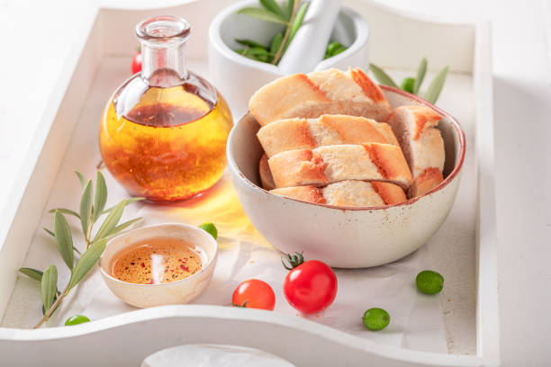 Fresh bread served with tomatoes oil with herbs. Bread with olive oil and dried tomatoes.