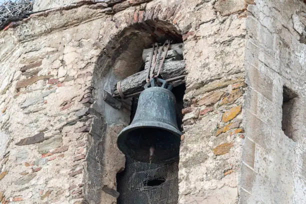 Photo of bell of a church steeple fastened with an old wooden anchoring system