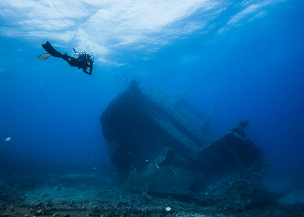 istock Seascape of a scuba diver approaching a ship wreck 1422455462
