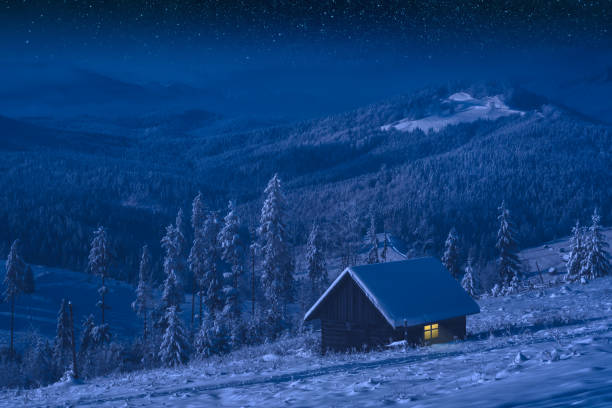 istock Wooden house in a moonlight at night 1422458661