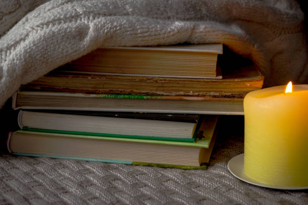 istock A stack of books and a warm sweater on a knitted plaid 1422458871
