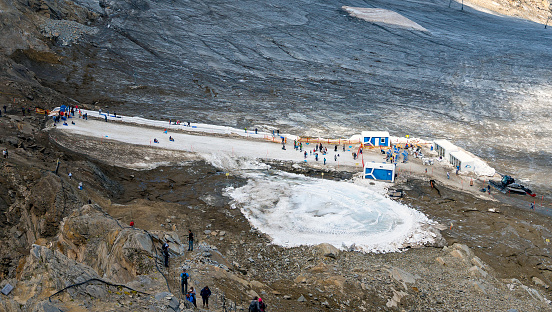 ice arena made from snow relicts beside the glacier Schmiedingerkees on the mountain Kitzsteinhorn, in summer, Austria