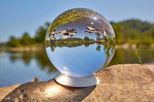 A glass ball lies in the sun on the Ruhr.