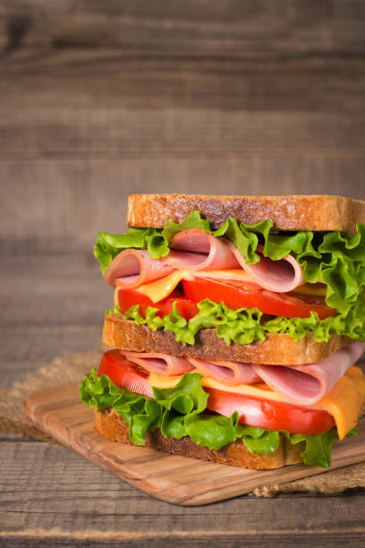 istock Club sandwich with ham, cheese, tomato and lettuce. 1422461206