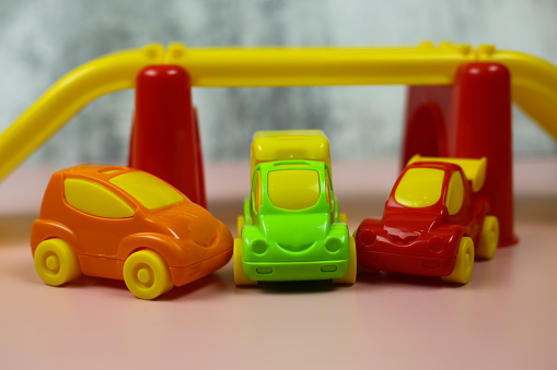 Collection of different  types of used toy cars on wooden background.