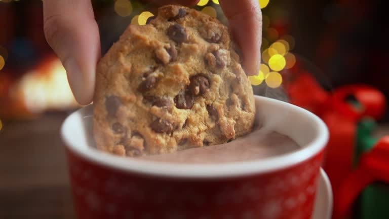 Dunking a Chocolate Chip Cookie in a Cup of Hot Cocoa in Slow Motion, Christmas Rest by the Fireplace