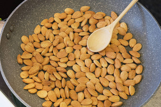 istock Roasting almond kernels in a frying pan 1422469059