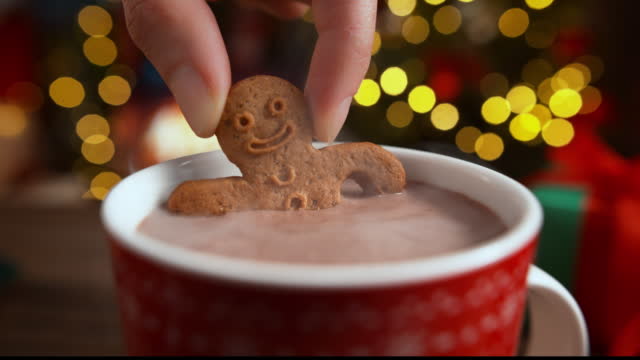Dipping a Gingerbread Man Biscuit in a Cup of Hot Chocolate in Slow Motion, Christmas Rest by the Fireplace
