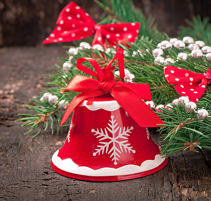 Christmas decorations and fir branches on the old wooden background