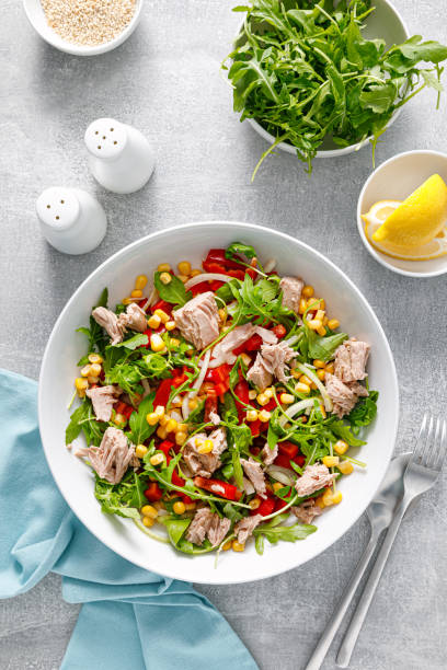 istock Canned tuna salad with arugula and fresh vegetables, top view 1422469387