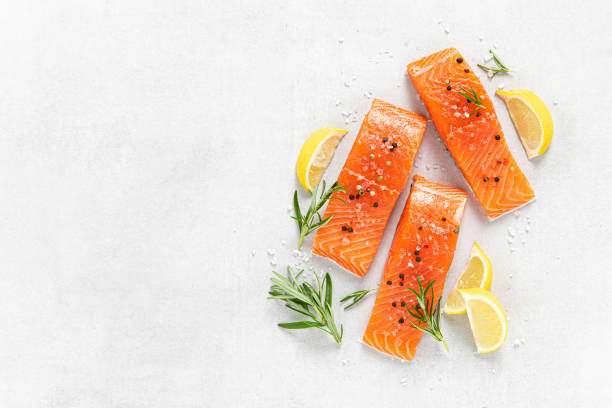 istock Salmon. Fresh raw salmon fish fillet on white background 1422470086