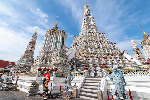 Bangkok, Thailand - September 11, 2019: tourists visiting the Wat Arun or Wat Chaeng temple, is situated on the west bank of the Chao Phraya River. Wat Arun or temple of the dawn is partly made up of colourfully decorated spires and stands majestically over the water.