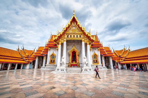 Bangkok, Thailand - September 11, 2019: tourists at Wat Benchamabophit Dusitwanaram landmark (marble temple) in Bangkok, Thailand / Outside of Wat Benchamabophit Dusitwanaram