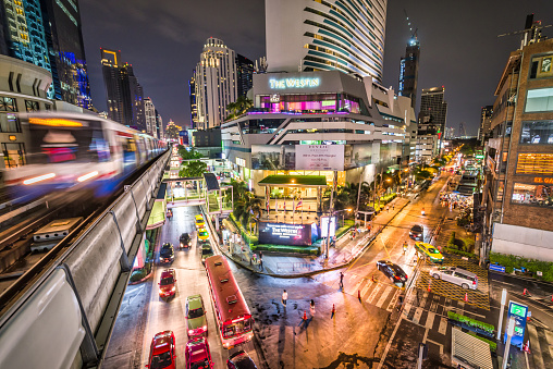 Bangkok, Thailand - September 11, 2019: BTS Sky Train is running in downtown pass through skycrapers business buildings at night