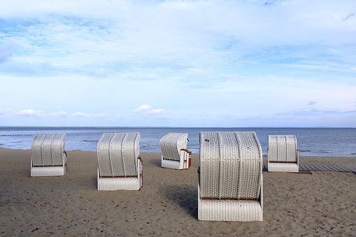 Beautiful young asian woman with hat arm up relaxing on beach chair, Summer happy beach vacation concept.