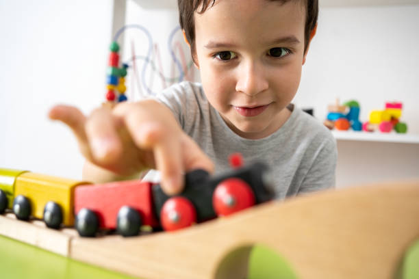 istock kid playing with wooden toy train 1422473367