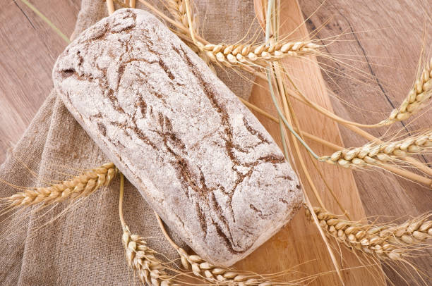 istock Bread rye spikelets on an wooden background 1422479778